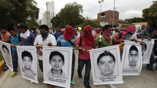 Photo courtesy AP/Eduardo Verdugo: Protest marchers show faces of the missing, Acapulco, Oct 2014
