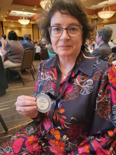 Mystery author Carmen Amato with award